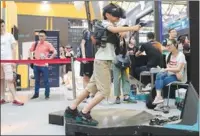  ??  ?? A visitor tries a 4D VR gaming system at this year’s China Joy.