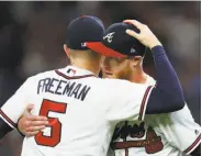  ?? John Bazemore / Associated Press ?? Braves pitcher Mike Foltynewic­z hugs Freddie Freeman after a win over the Nationals.