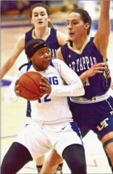  ?? KYLE FRANKO — TRENTONIAN PHOTO ?? Ewing’s MyAsia Jackson (12) looks for space to move as she’s defended by Old Tappan’s Alexandra George (21) during the Group III state final at RWJ Barnabas Health Arena in Toms River on Sunday afternoon.