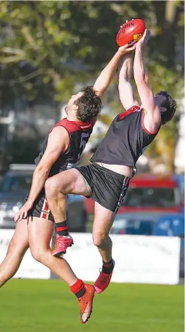 ?? ?? James Davidson stretches to mark over his Warragul teammate in the senior game at Western Park.