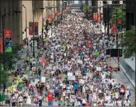  ?? AP/Chicago Sun-Times/JAMES FOSTER ?? Protesters fill the street Saturday in Chicago in a march against the enforced separation of children and their families who are arrested at the U.S.-Mexico border.