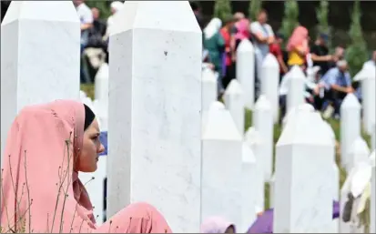  ?? (AFP) ?? Bosnian Muslim survivors and family members of the victims of Srebrenica 1995 massacre gather before the burial ceremony of caskets with body remains at the memorial cemetery in village of Potocari, near Eastern-Bosnian town of Srebrenica, yesterday. It marked the 26th anniversar­y of the massacre during which more than 8,000 Bosnian non-Serbs went missing to be found buried in mass graves years after the war ended.