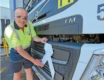  ??  ?? Tanker operator Roger Rees puts a white ribbon on a tanker at Fonterra’s Whareroa site.