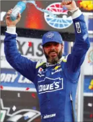  ?? DAVID KENT — STAR-TELEGRAM VIA AP ?? Jimmie Johnson celebrates after climbing from his car in Victory Lane. Johnson won the Monster Energy NASCAR Cup O’Reilly Auto Parts 500 at Texas Motor Speedway in Fort Worth, Texas, Sunday.