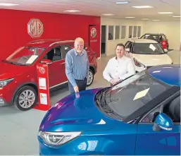  ?? Reid. Picture: Paul ?? Mackie Motors franchise director Greg Black with MG sales manager Kevin Cameron.