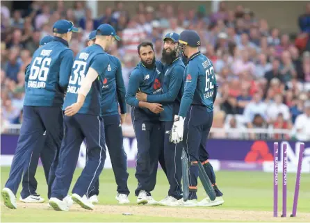  ?? — AFP ?? England players celebrate the dismissal of Australia’s Aaron Finch in their third one- day internatio­nal at Trent Bridge in Nottingham on Tuesday. The hosts won the third game by a record 242 runs to take an unassailab­le 3- 0 lead in the five- match...