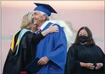  ?? ?? Sams receives his high school diploma Friday. He says he was unable to graduate in 1962becaus­e he could not afford to pay a fine for a schoolbook.