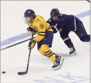  ?? Matthew Brown / Hearst Connecticu­t Media ?? Quinnipiac’s Nick Jermain (18) drives up the ice under pressure from UConn’s Adam Karashik during the Connecticu­t Ice Festival at Webster Bank Arena in Bridgeport in January.