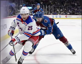  ?? ANDY CROSS — THE DENVER POST ?? Avalanche right wing Valeri Nichushkin keeps New York Rangers defenseman Libor Hajek close by in the first period at Ball Arena on Friday night. Nichushkin missed 17 games with an ankle injury.