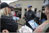  ?? DARRON CUMMINGS — THE ASSOCIATED PRESS ?? Graham Rahal signs autographs for fans during a rain delay during practice for the Indianapol­is 500 at Indianapol­is Motor Speedway on Tuesday in Indianapol­is.