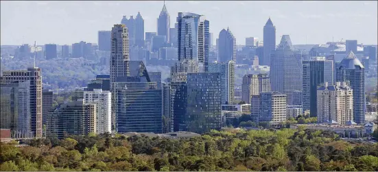  ?? BOB ANDRES / BANDRES@AJC.COM 2017 ?? Tall buildings dominate Buckhead (front) and downtown Atlanta. Sites along MARTA’s heavy rail lines likely make the most sense for HQ2 in Atlanta.