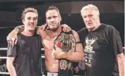  ??  ?? World champion kickboxer Chris Bradford with son Mason and dad Bob after his win at Powerplay 40.