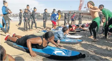  ?? Picture: SUPPLIED ?? NEW EXPERIENCE: The East London Waves for Change (W4C) team treat their mothers, aunts, sisters and caregivers to a surf lesson at their Women’s Day celebratio­n at Orient Beach last week. Fun was had by all, especially the youngsters trying to get...