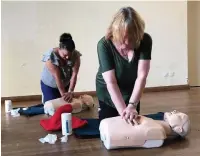  ??  ?? First aid course Doris Vasse and Ann Rennie try resuscitat­ion techniques