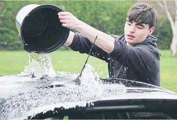  ?? ?? Pupils washed their teachers’ cars to raise money.