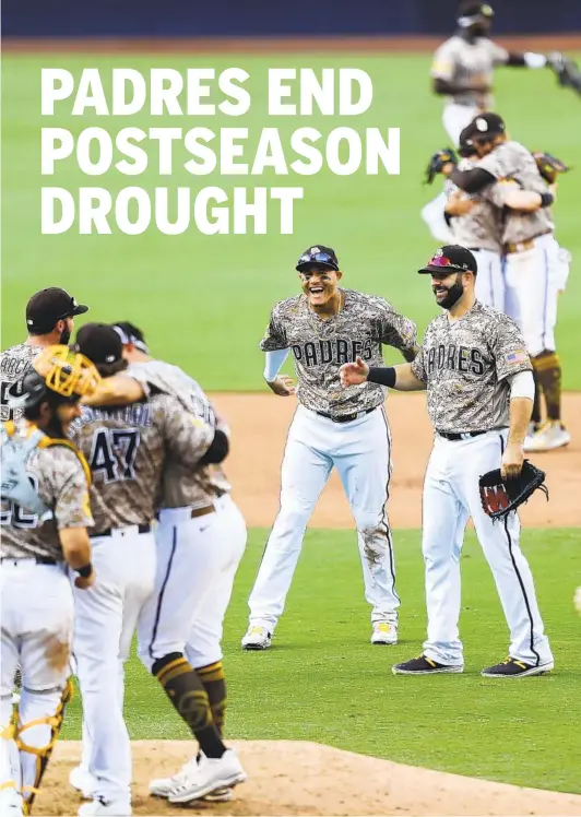  ?? K.C. ALFRED U-T ?? Padres players, including Manny Machado and Mitch Moreland (center), celebrate clinching the team’s first playoff berth since 2006 with a 7-4 win over the Mariners.