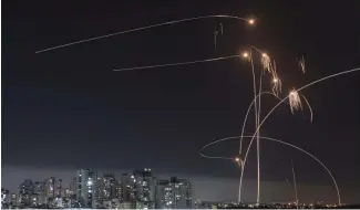  ?? ?? Israel's Iron Dome missile defense system fires intercepto­rs at rockets launched from the Gaza Strip, in Ashkelon, southern Israel. Thursday, May 11, 2023.