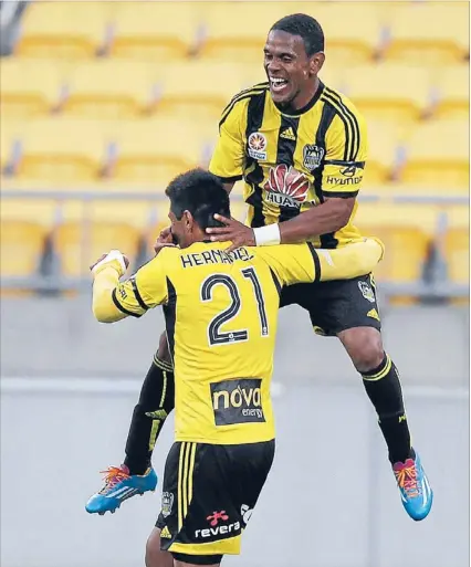  ?? Photo: KENT BLECHYNDEN/ FAIRFAX NZ ?? Party time: Costa Rican cobbers Kenny Cunningham, right, and Carlos Hernandez celebrate Cunningham’s first half goal for the Wellington Phoenix during last night’s 1- 1 draw with the Central Coast Mariners at Westpac Stadium.