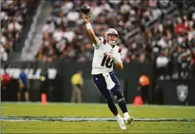  ?? Ashley Landis / Associated Press ?? Patriots quarterbac­k Mac Jones throws a pass during a preseason game against the Raiders on Aug. 29 in Las Vegas.