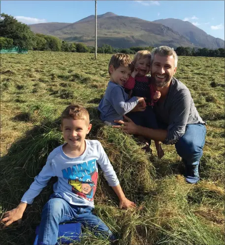  ??  ?? Ruairí Spillane pictured duringa recent trip home near his family home in Beaufort with Tomies Mountain in the background. He is pictured with nephews Fionn &amp; Mally and niece Shae.