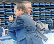  ?? [PHOTO BY K.T. KING, UCO] ?? University of Central Oklahoma wrestling coach Todd Steidley, right, and former Bronchos coach David James embrace as UCO’s 1987 national champion team is introduced at a dual against Fort Hays State on Feb. 5 in Edmond. James, who will be inducted...