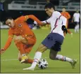  ?? KIRSTY WIGGLESWOR­TH — AP ?? Gio Reyna, right, of the United States, fights for the ball with Wales’ Rabbi Matondo during the friendly soccer match Thursday in Wales.