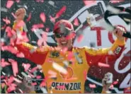  ?? STEVE HELBER - THE ASSOCIATED PRESS ?? Joey Logano celebrates after winning the NASCAR Cup Series auto race in Victory Lane at Richmond Internatio­nal Raceway in Richmond, Va., Sunday.