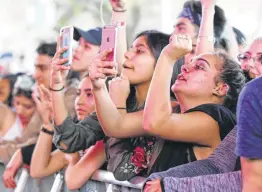  ?? Kin Man Hui / Staff file photo ?? Fans of singer and rapper Doja Cat record her show as the Botanica Music Festival kicked off its first year at Six Flags Fiesta Texas in March 2018.