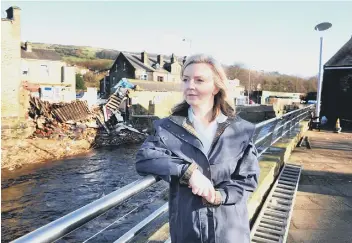  ??  ?? Elizabeth Truss MP, Secretary of State for Environmen­t, Food and Rural Affairs makes a visit to see Mytholmroy­d following the floods over Christmas.