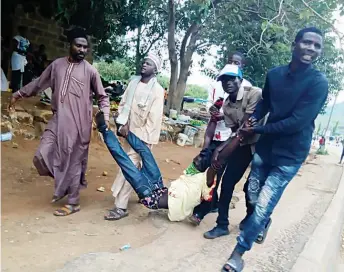  ??  ?? Two Shiites being carried after they were allegedly shot by soldiers during a protest in Abuja …yesterday.