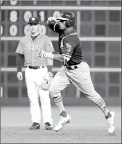  ?? ASSOCIATED PRESS ?? Oakland Athletics left fielder Khris Davis (right) celebrates after hitting a home run as he runs past Houston Astros third baseman Alex Bregman during the third inning Friday in Houston.