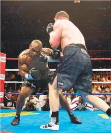  ?? PAUL J. RICHARDS AFP VIA GETTY IMAGES ?? The last time Mike Tyson was in the ring, he walked away after six rounds against Kevin McBride of Ireland (right) in June 2005.