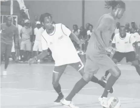  ??  ?? Gregory Richardson of Sparta Boss dribbling Deon Alfred of Tiger Bay at the National Gymnasium in the Petra Organizati­on Futsal Championsh­ip.