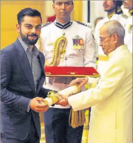  ?? AP PHOTO ?? Virat Kohli is awarded the Padma Shri by President Pranab Mukherjee on Thursday. Deepa Malik and PR Sreejesh were the other recipients of the award along with the India cricket captain.