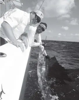  ?? STEVE WATERS For the Miami Herald ?? Howard Walters of Pembroke Pines caught this sailfish on Bouncer’s Dusky 33 with Capt. Bouncer Smith that mate Abie Raymond is about to release.