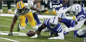  ?? MICHAEL CONROY — THE ASSOCIATED PRESS ?? Green Bay Packers’ Marquez Valdes-Scantling, left, fumbles a catch during the overtime of Sunday’s loss to the Indianapol­is Colts. The Colts’ DeForest Buckner, left, recovered.