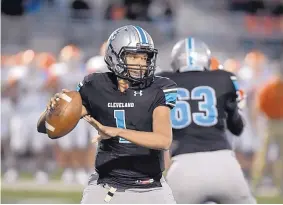  ?? ROBERTO E. ROSALES/JOURNAL ?? Cleveland quarterbac­k Jeff Davison looks for an open receiver during Fridays home game against Artesia at Cleveland High School.