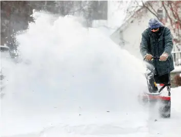  ?? DARREN MAKOWICHUK ?? Like many Calgarians, Jack Nodwell fired up his snowblower to clear walks and driveways as the city received another dump of snow and cold temperatur­es during the weekend.