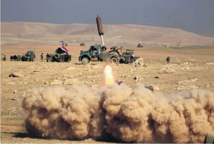  ?? Zohra Bensemra / Reuters ?? Members of the Iraqi rapid response forces fire a missile at ISIL militants south of Mosul yesterday.