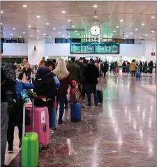  ??  ?? Queues of people at an airport looking to get flights home, scenes like this are visible at airports all around the world right now. Pic: Adria Salido Zarco/NurPhoto via Getty Images