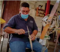  ??  ?? Dayvi Pastrana prepares wood airplane propellers for drones at their workshop in San Nicolas de Bari, Mayabeque province, Cuba