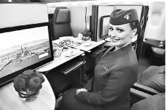  ?? — AFP photo ?? An air hostess sits in the ‘QSuite’ business class of a Qatar Airways Boeing 777 jet airliner on display at the Internatio­nal Paris Air Show in Le Bourget outside Paris. Qatar Airways, its Middle Eastern business pressured by a diplomatic row with...