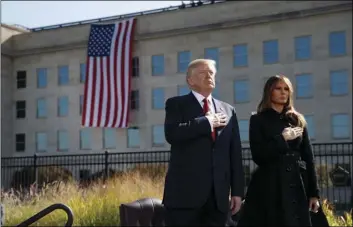  ?? AP PHOTO/EVAN VUCCI ?? President Donald Trump and first lady Melania Trump stand as “Taps” is played during a ceremony to mark the anniversar­y of the Sept. 11 terrorist attacks, Monday, at the Pentagon.