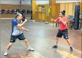  ?? HT PHOTO ?? India’s boxing high-performanc­e director Santiago Nieva (L) and n
Pooja Rani engage in shadow sparring during the ongoing national camp at NIS, Patiala.