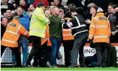  ?? REX FEATURES ?? Clash: fans invade the pitch