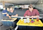  ??  ?? Joshua Mckerrow and Chase Cook, a photograph­er and reporter, above, work on yesterday’s edition. Below, Jarrod Ramos, the suspected gunman