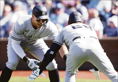  ?? Jamie Squire / Getty Images ?? The Yankees’ Aaron Judge, left, is congratula­ted by Josh Donaldson after hitting a home run during the ninth inning on Sunday.