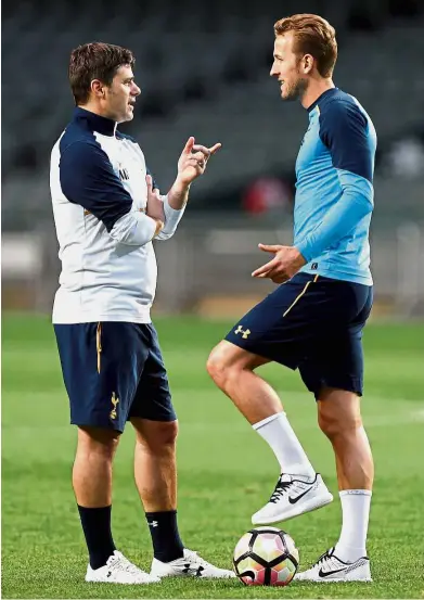  ?? — Reuters ?? Listening to the boss: Tottenham Hotspur manager Maurico Pochettino (left) having a word with Harry Kane during training in Hong Kong yesterday. Spurs play Kitchee SC in a friendly.