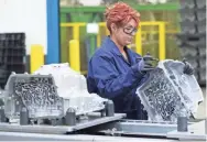  ?? MARK HOFFMAN / MILWAUKEE JOURNAL SENTINEL ?? Dzenana Hadziosman­ovic inspects a transmissi­on case for a Ford pickup truck at Nemak, an automobile industry supplier that manufactur­es die-cast aluminum parts in Sheboygan.