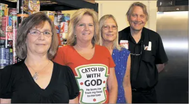  ?? STAFF PHOTOS BY SARA NEWMAN ?? Evelyn Lawrence, Jennifer Batts, Debbie Bennett and the Rev. Michael Briese of Saint Mary Catholic Church, Newport in Charlotte Hall stand in the Good Shepherd Food Pantry that opened at the church in February. The pantry is an initiative that began...